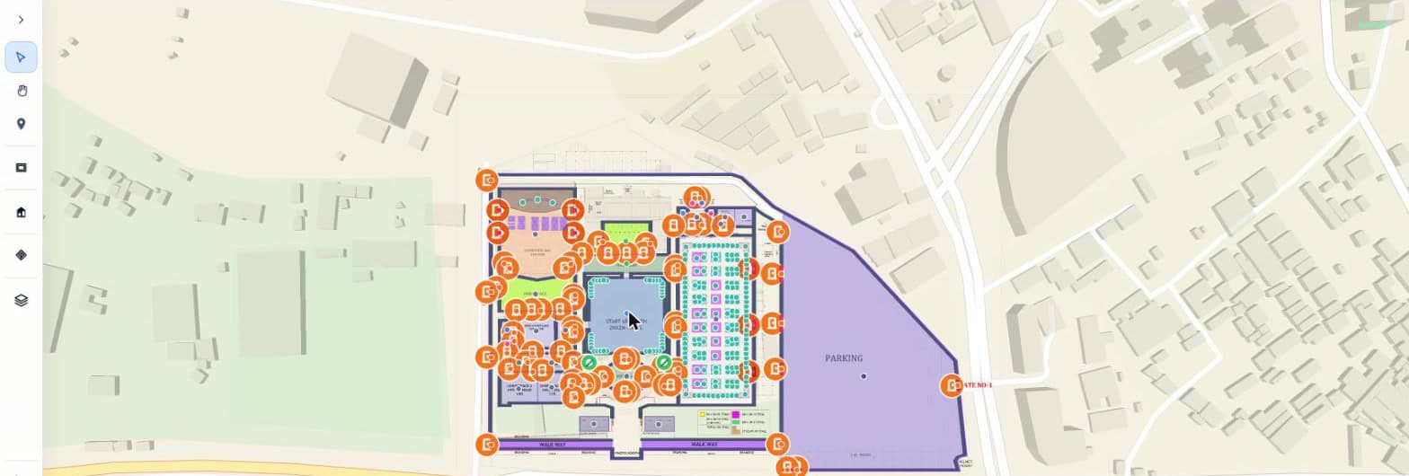 The Mapnyx Studio editor with the venue drawn over the real site: hall and booth polygons, colour-coded zones, walkways, a parking boundary and a place pin on every point of interest, with the drawing toolbar down the left.
